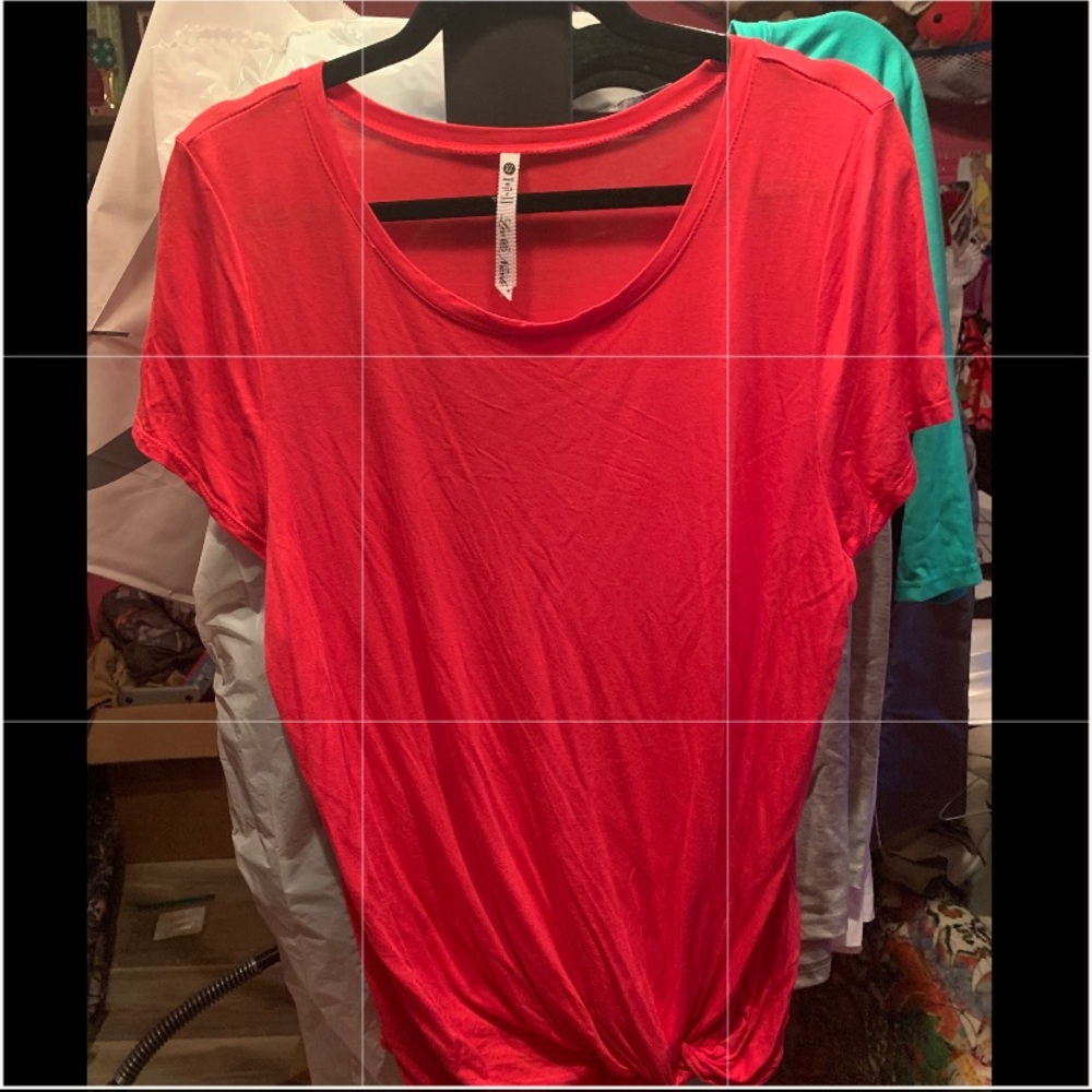 Pink tee with twist at the bottom.